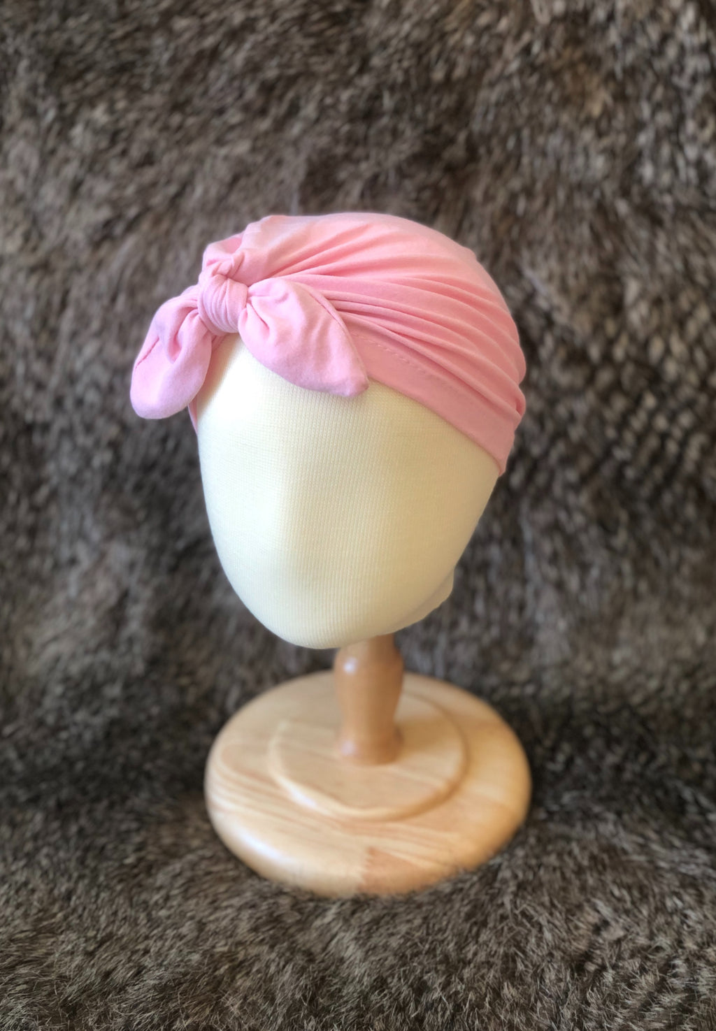 Light pink, turban-style head cover with a knot in the front